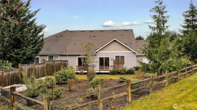 Back yard has garden beds with watering system
