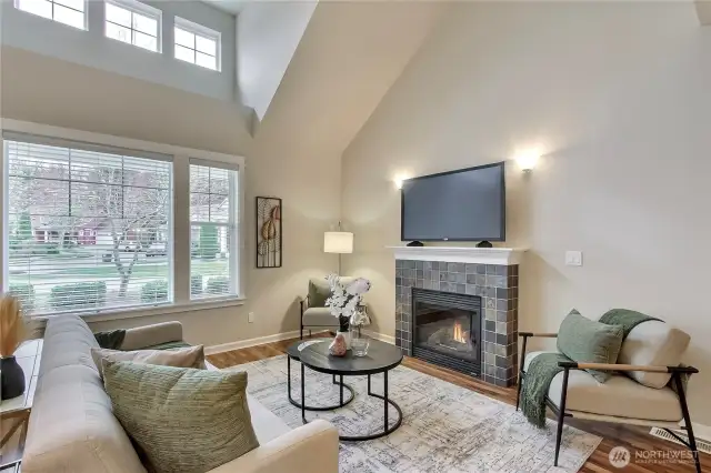 Cozy gas fireplace and wood flooring throughout.