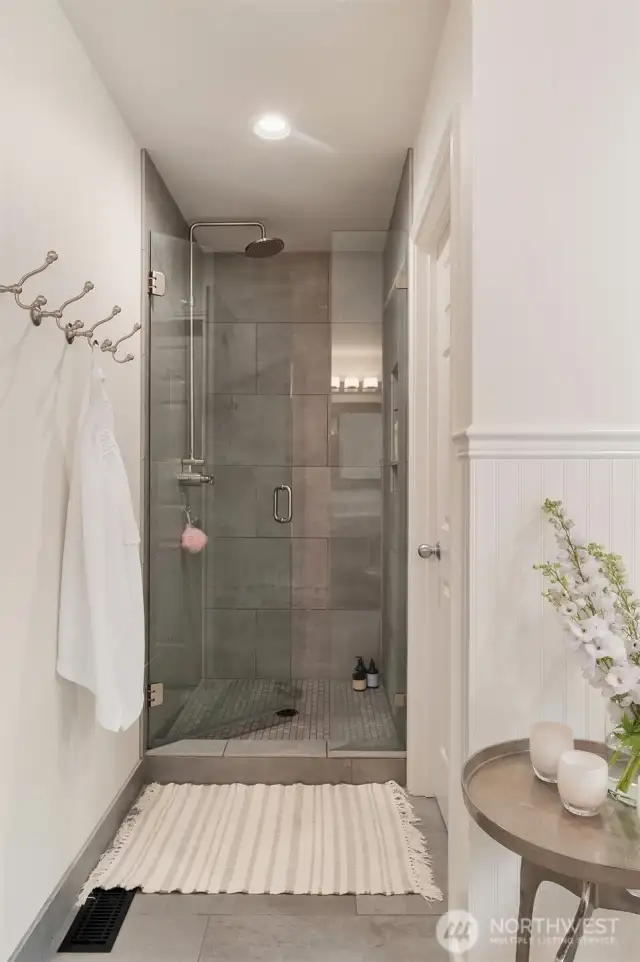 Premium Hansgrohe fixtures enhance the sophistication of the shower area.