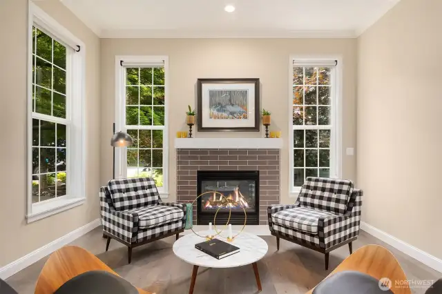 Walls of windows and a cozy gas fireplace create a warm, inviting ambiance.