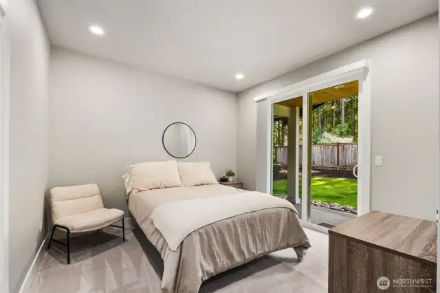 Downstairs guest bedroom with private outdoor seating area.