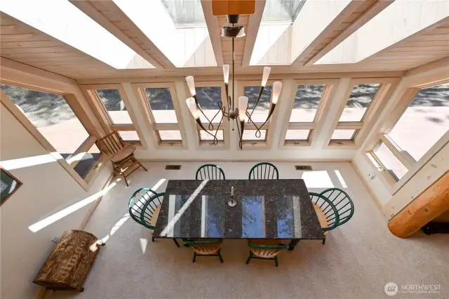 Bright dinning area with windows and skylights