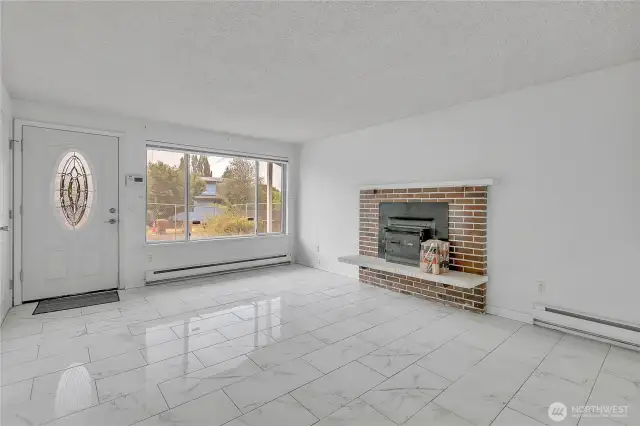 Welcome to your new home, entering through your tiled front door and your fireplace with insert to take the chill off of the day.
