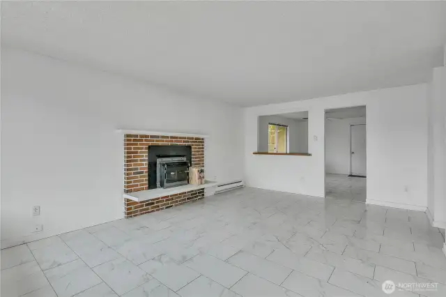 Wonderful living room with tiled flooring and fireplace insert, with pass through to dining room.