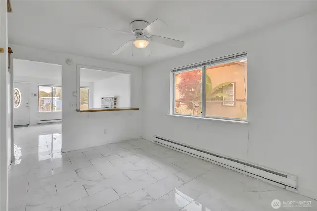 View of Dining Room with pass through to living room and ceiling fan in dining room.
