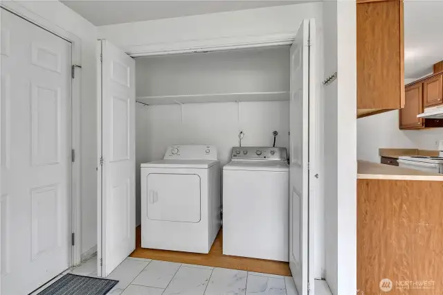 Washer and Dryer in Dining area next to garage and kitchen.