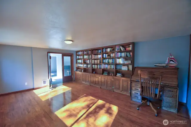 Bonus room with hardwood floors and built-ins.