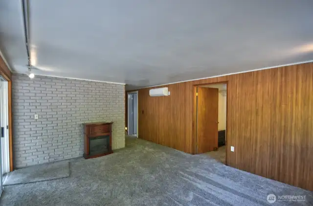 Primary bedroom with sliding glass door, walk-in closets and fully remodeled bath.