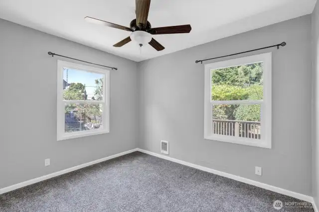 Main floor Primary bedroom with ceiling fan