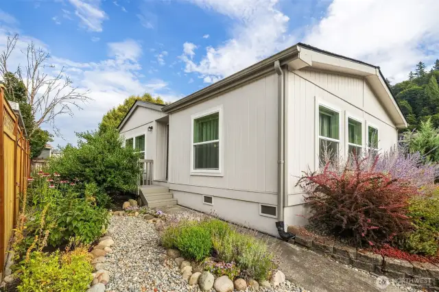 North Side of home, features a lovely, landscaped approach to the front door.