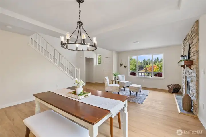Cute dining room open to living room looking out to the West through the window.