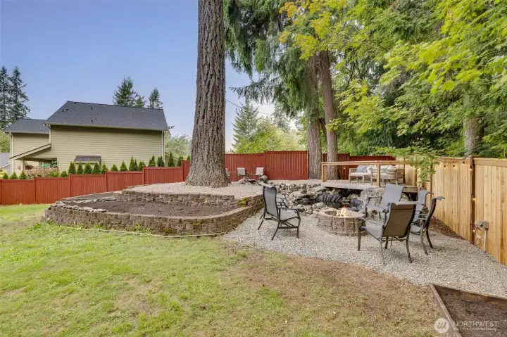 Daytime picture of the firepit area, enjoying the waterfeature and private peaceful backyard.