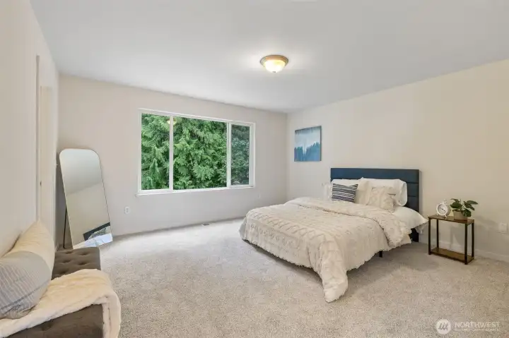 Primary bedroom looking out onto the backyard and Native Growth Protection area!
