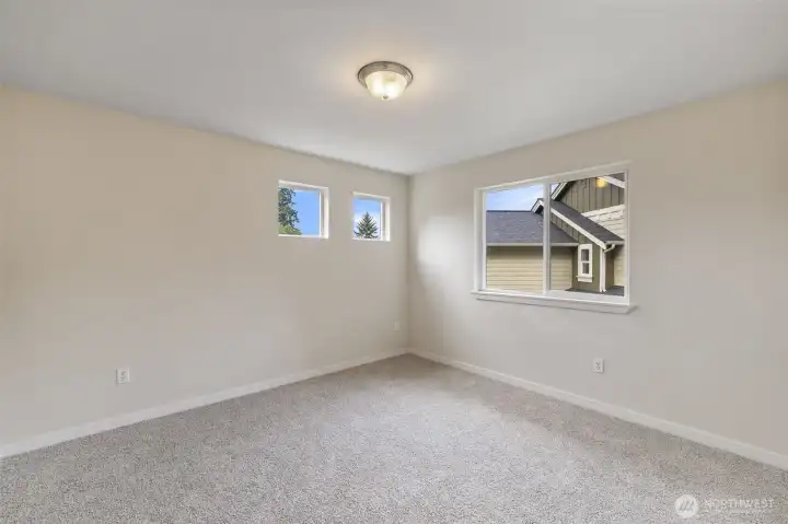 Generous sized Bedroom, with nice lighting, new trim and extra upgraded padding underneath all new carpeted upstairs!