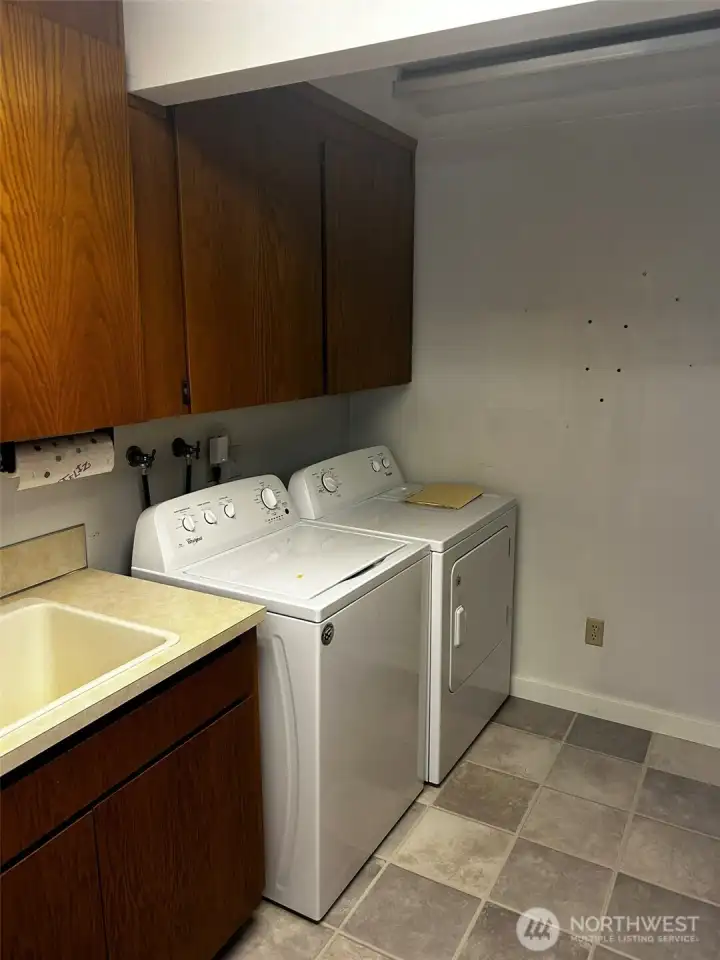 Laundry features a sink and drying rack for clothes