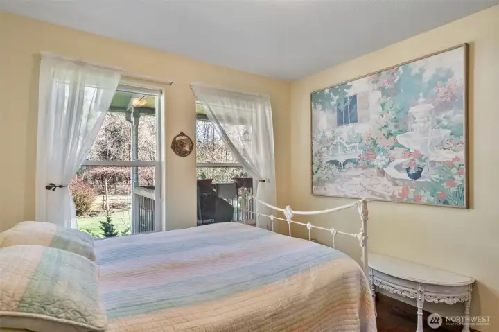 This cozy and bright bedroom looks out to the back yard.