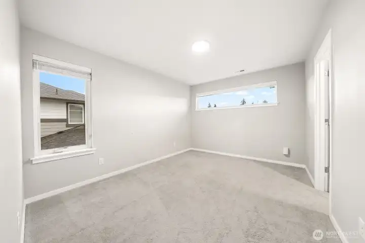 Bedroom 3 with walk in closet and a custom closet organizer