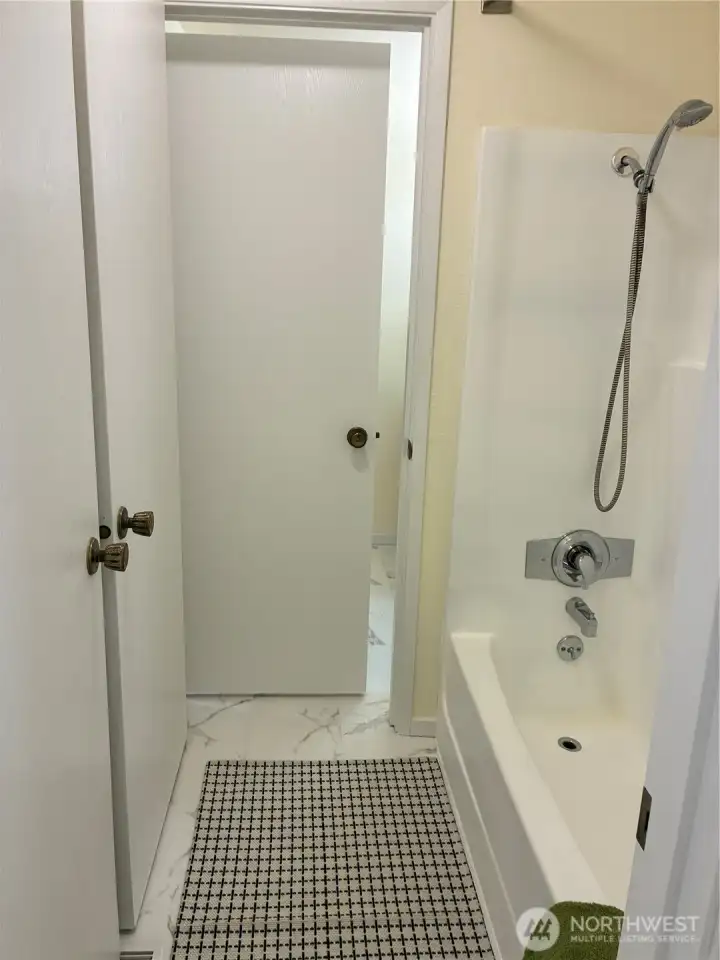 Shower/tub is accessible from hall bathroom and the primary bathroom.