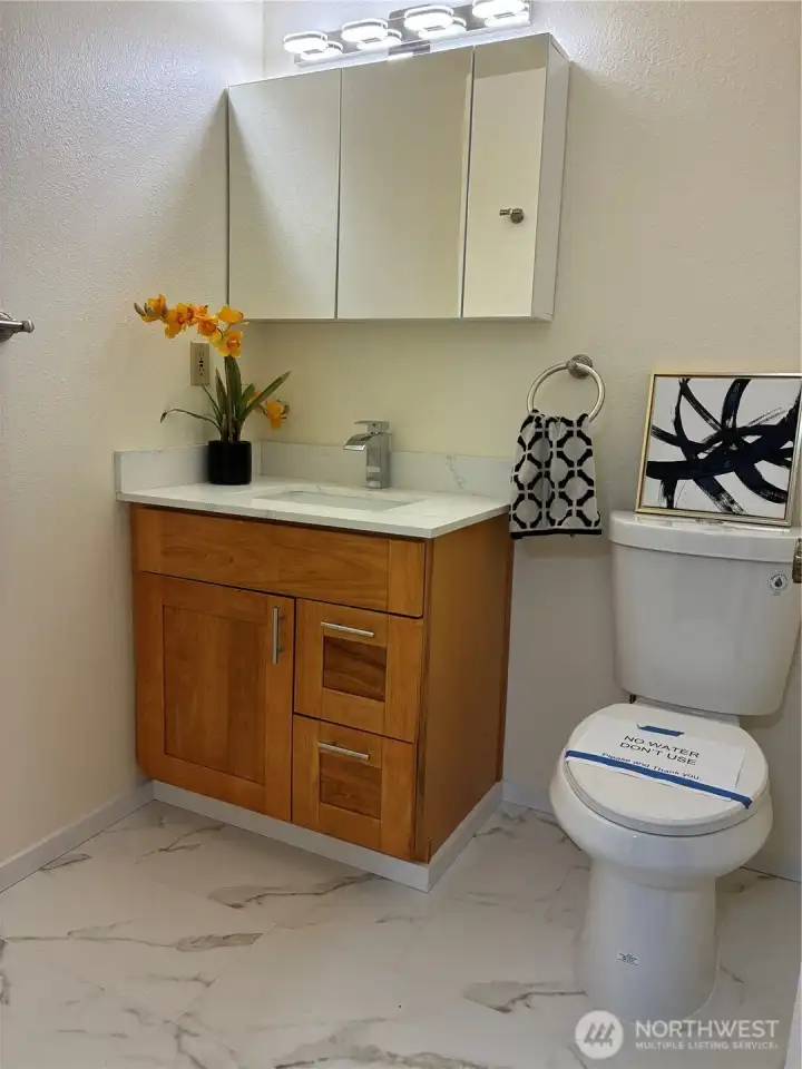 Hall bathroom is fully updated with tile floor.