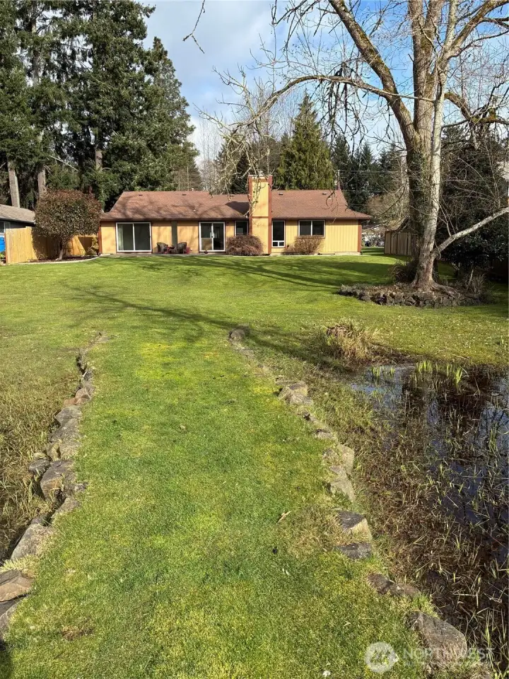 Rear of home from water's edge, no bank water frontage of 77 ft.