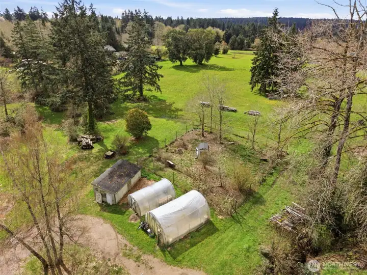 Sun-filled grow houses and fenced garden area