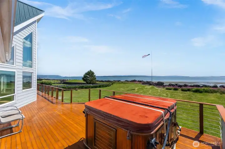 Sundeck & hot tub with views across --