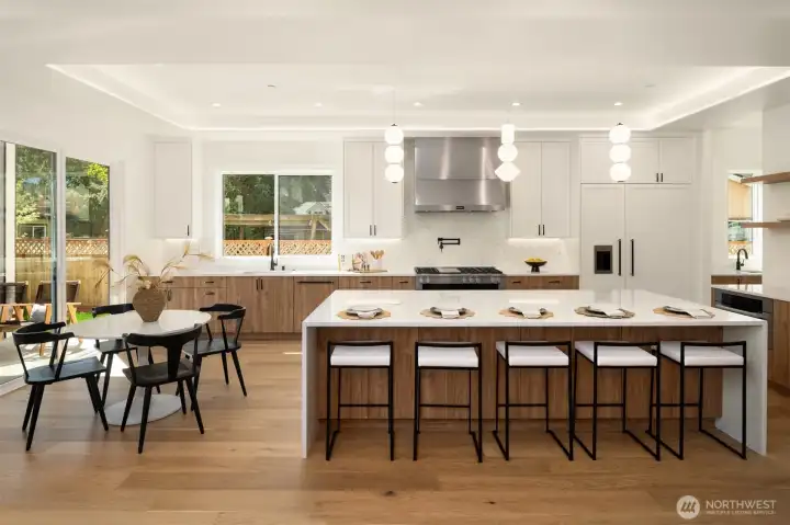 Large waterfall center island, custom cabinetry make this kitchen warm and welcoming!
