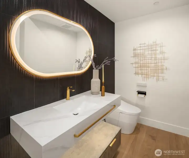 A dramatic powder room with a TOTO smart bidet elevates the experience for every guest.