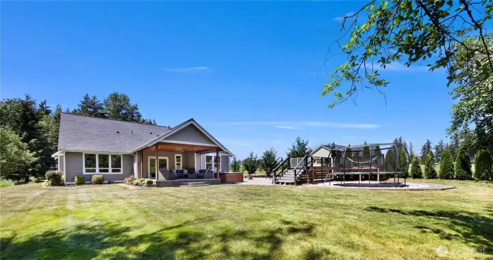 Here is a back view of the home with covered patio and so much room to spread out.