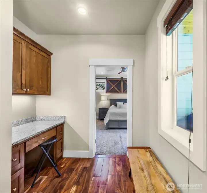 Desk are off kitchen and entry in master suite.