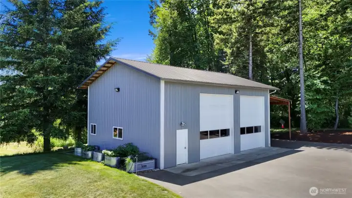 2 Bay shop with lean too iwit RV hookups and storage area, raised garden beds.