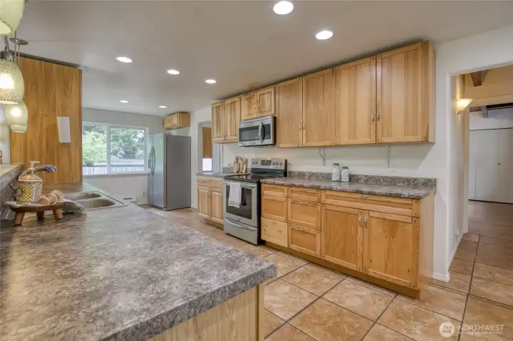 Spacious kitchen. All stainless steel appliances stay. New dishwasher in 2025, stove and fridge purchased in 2015 Spacious kitchen. All stainless steel appliances stay. New dishwasher in 2025, stove and fridge purchased in 2015
