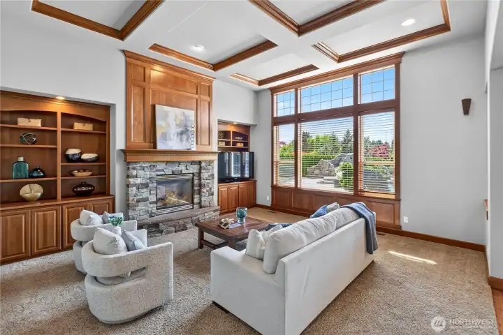 Large family room, with built-ins, coffered ceilings and wood wrapped windows & beautiful vies of backyard.
