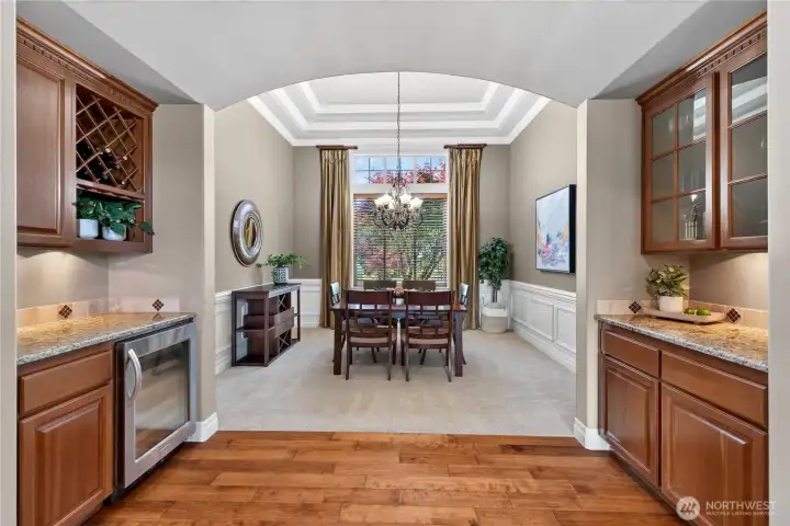 Large dining room with coffered ceilings and bar area.