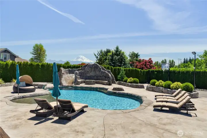 Relax in your resort style pool complete with rock slide, sun shelf, waterfall feature, hot/cold rinse shower, pool lights & fire pit area.