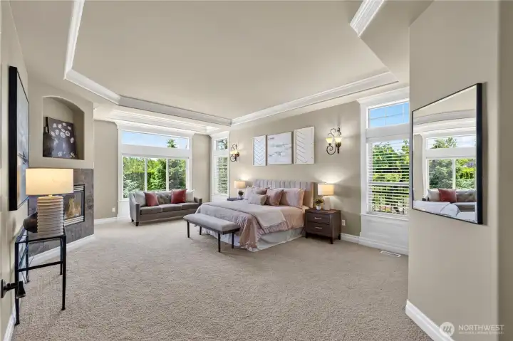Luxurious primary suite with fireplace, sitting area, patio access & bath ensuite.