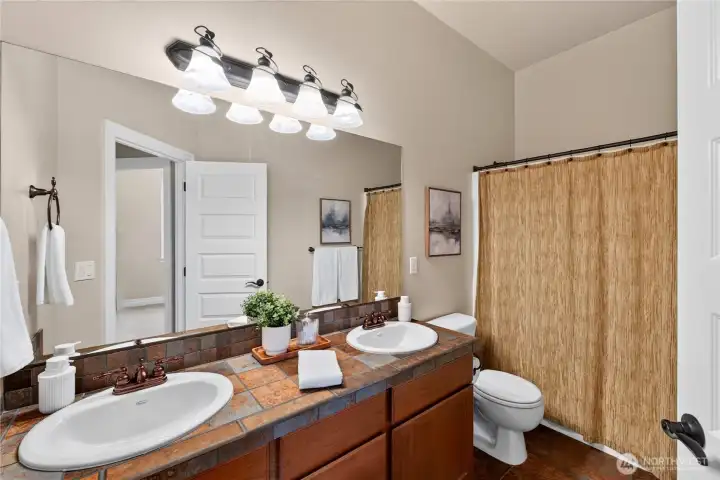 Full bath with double sinks.