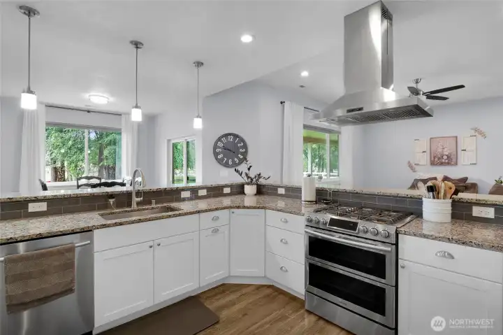 Quartz countertops and stainless steel appliances shine.