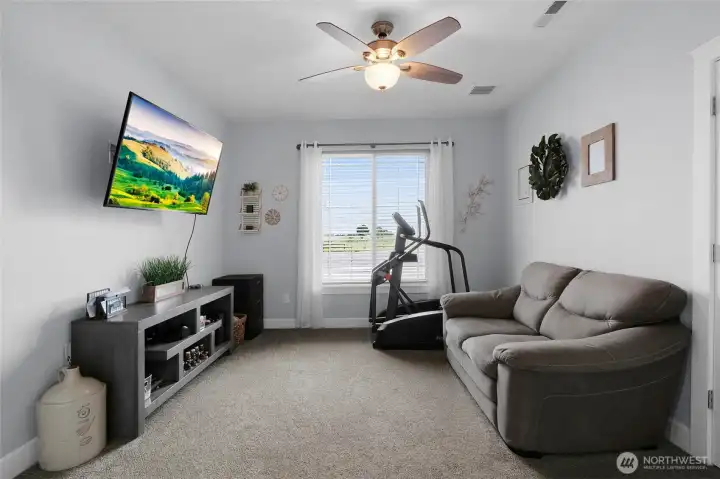 The fifth bedroom offers exceptional flexibility as a guest room, home office, hobby space, or workout room.