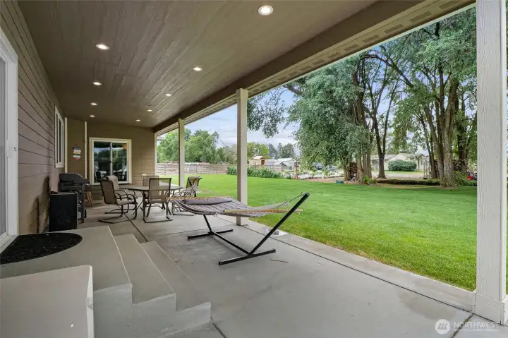 Covered outdoor living overlooking your acreage, pasture, and peaceful surroundings.