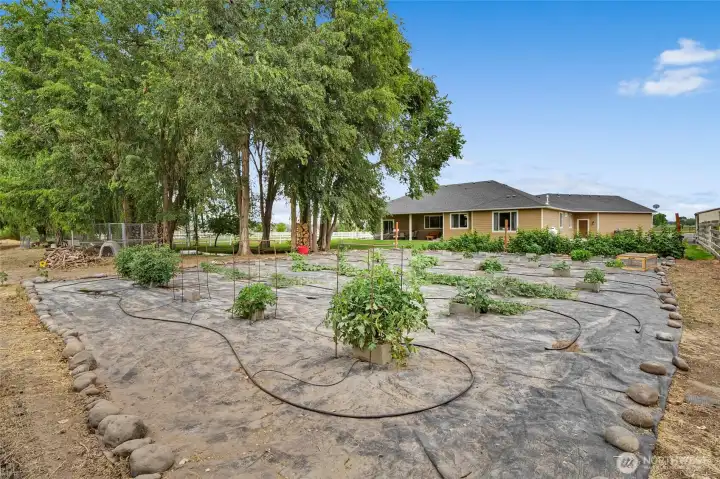 Fenced pasture, garden space, and a creek create the perfect backdrop for country living.