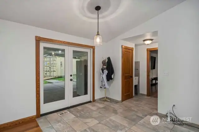 Eating Nook with French Doors leading to the large covered outside Living Area. Do not fall in love with the 40' Container, it goes with the Sellers!