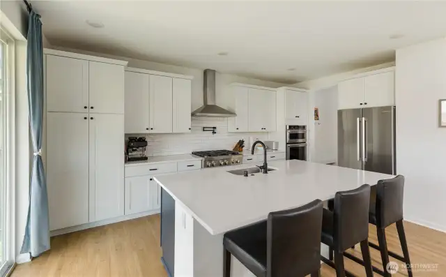 Another view of the kitchen. the doorway next to the refrigerator leads to the pantry, a mudroom area, and then on to the two car garage.