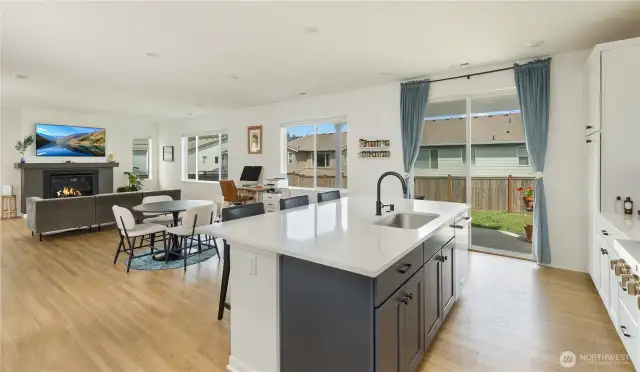 The great room has a natural gas fireplace (not propane) and large windows overlooking the backyard and bringing in natural light.