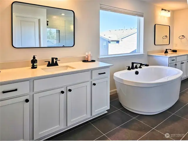 The five-piece primary bathroom with soaking tub, and plenty of counter and storage space.