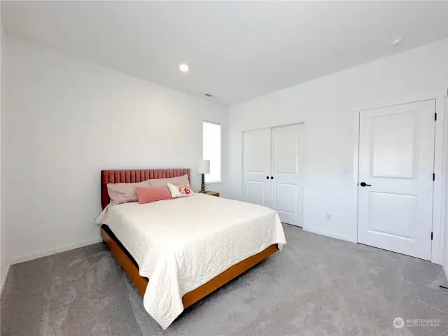 The guest bedroom on the main floor is bright and full of light, and ample closet space.