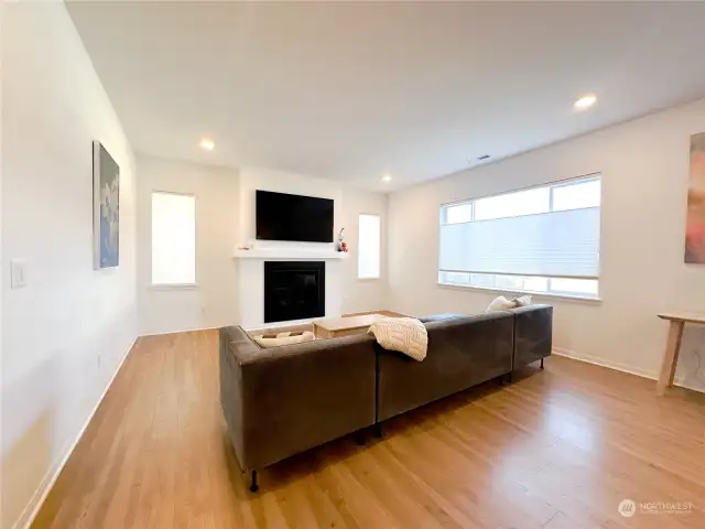 The living area part of the great room has a natural gas fireplace (not propane) and large window overlooking the backyard.