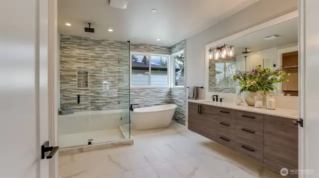 Sumptuous Primary 5-Piece Bath featuring heated tile floor, floating double-sink vanity, soaking tub, & rain shower head.