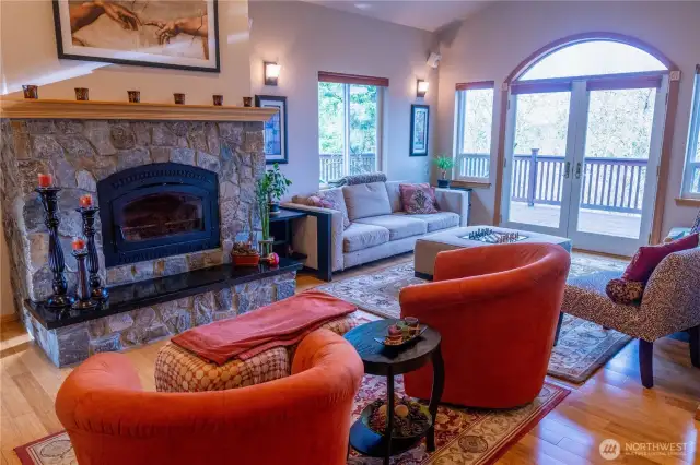 Upon entry, one is welcomed by the natural light, accentuated by soaring ceilings, skylights & multiple windows. Then, the attention goes to the stone hearth around a wood burning fireplace that creates a focal point in the living room which boasts high quality craftsman finishes. Beautiful Bamboo wood flooring.