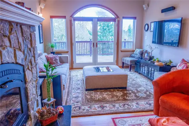 View of the living room towards the wall of windows with other conversation areas. Perfect for larger gatherings where guests have access to numerous spaces for intimate conversation.